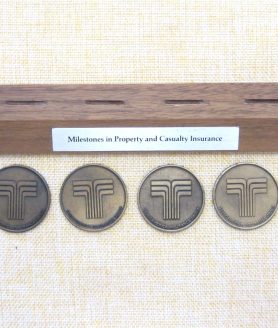 Transamerica Insurance History Desk Display with 6 Medallions
